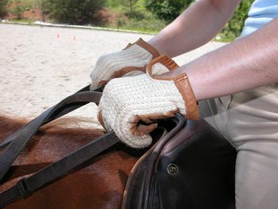 Photo 3. Hands turned downward too much. The palms are facing the ground. The rider will round her shoulders and pull on the reins.
