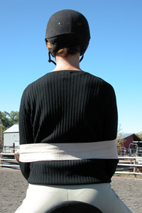 Photo 2. Rider with ace bandage. The bandage reminds the rider where her elbows belong. The bandage is snug but not tight so that she feels it if her elbows try to drift away. She could easily move her arms if necessary.