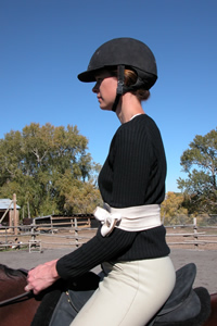 Photo 3. Rider with ace bandage from the side. Observe how the bandage is just above the rider's elbows and tied with a bow tie.