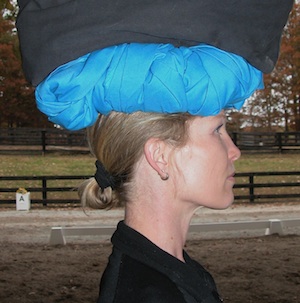 She has lengthened through her spine and her head is well aligned with the added weight in the bag on top of the turban.