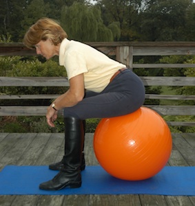 Photo 1. Fran is sitting in full seat on the ball (upright) with her feet shoulder width apart and a right angle at the back of her knees.