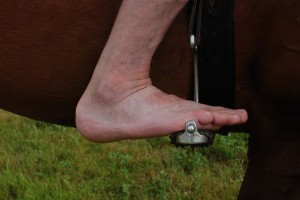 Photo 3. Foot correctly positioned with the balance point on the stirrup tread. The toes are relaxed and long with the heel sinking below the line of the tread.