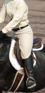 Photo 1. The rider’s knees are turned out and all her weight in on her feet, which are pushed forward. She will fall back toward the cantle on descent.