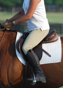 Photo 3. She is able to sit lightly in the center of the saddle because of her thigh support. At this moment you cannot tell if she is going up or down in rising trot because her position reversible without any loss of balance.