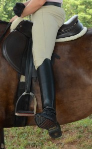 Photo 1. The rider’s leg is externally rotates from her hip. She is flexible enough to bring her leg to the side but in the stirrup the foot will move forward instead of back.